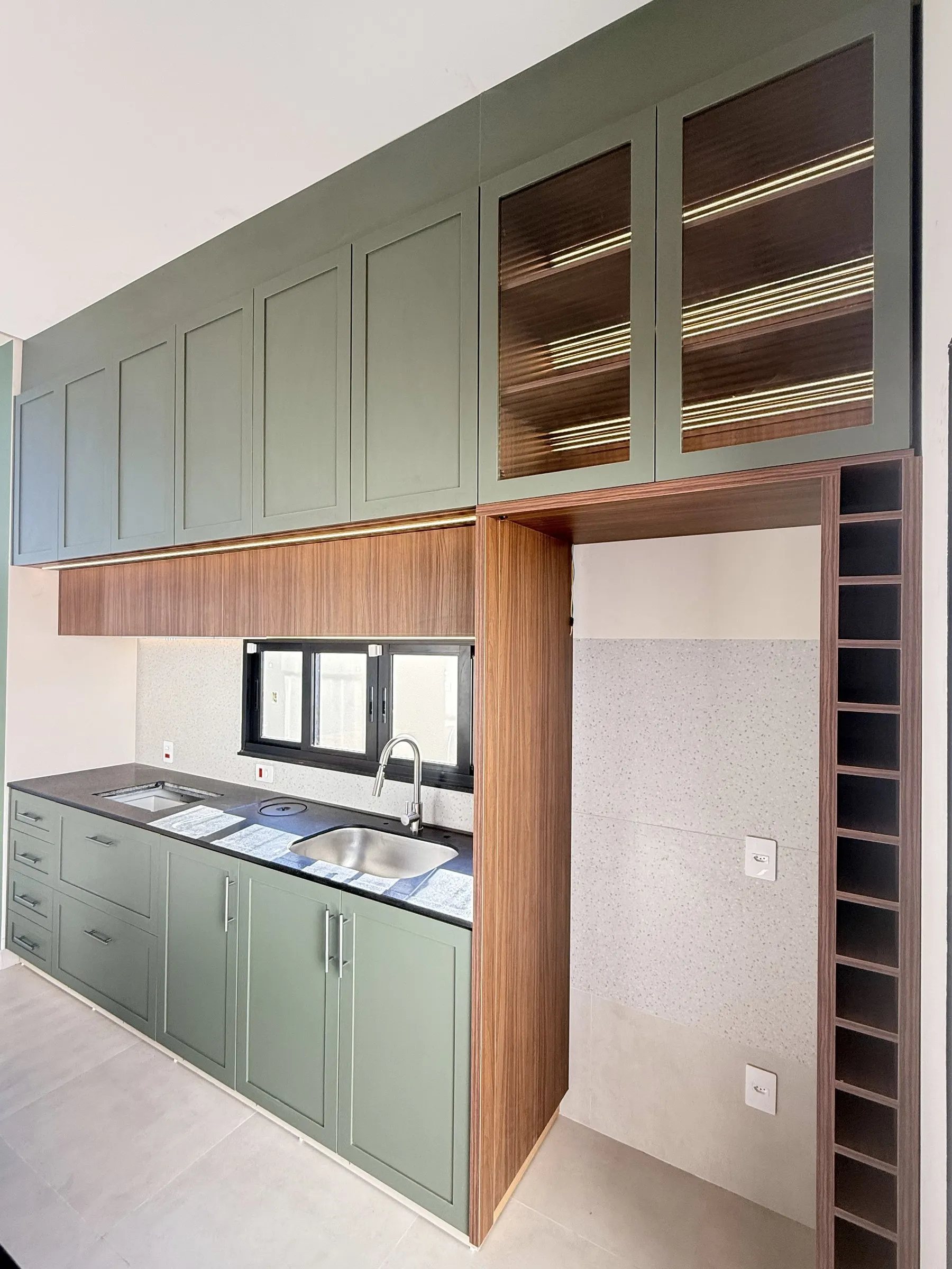 Cozinha provençal planejada verde, com portas de almofada, cristaleira em vidro canelado e adega vertical